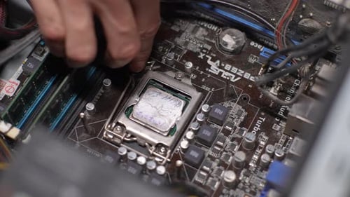 Hand Securing Bracket on Computer CPU