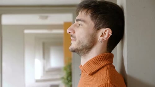 Young Adult Resting Against the Wall Looking Upward