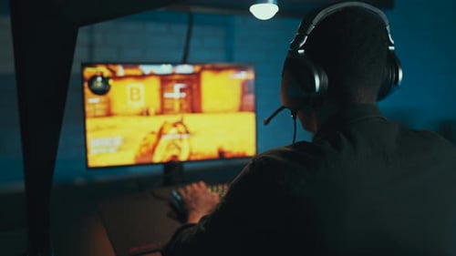 Male Gamer Plays First Person Shooter Game