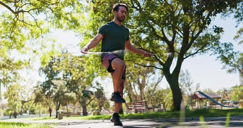 Man Jumping Rope for Fitness in City Park