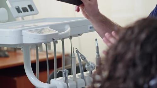 Dentist Explains X-Ray to Patient in Office