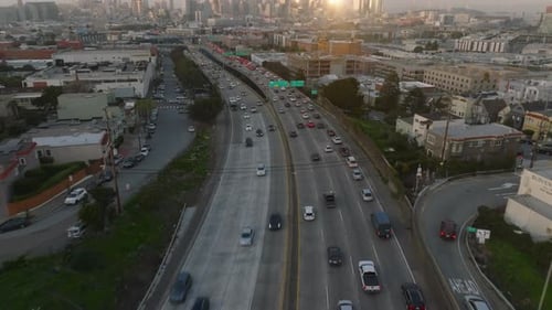 High Angle View of Vehicles Driving on Busy Multilane Highway in City Tilt Up Reveal of Cityscape