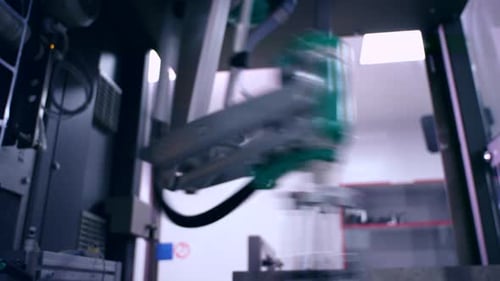 Robot Arm at Packaging Line. Automated Process. Factory Industrial Equipment. Modern Technology