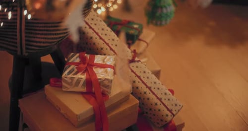 Wrapped Christmas Gifts Under Twinkling Tree