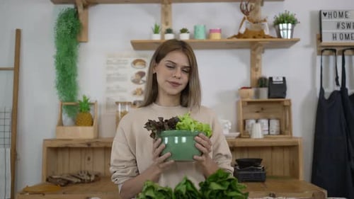 Woman Smiling Holding a Bowl of Salad