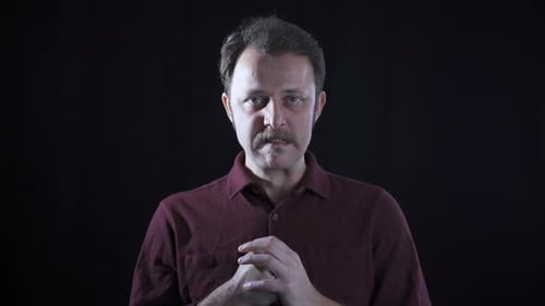Aggressive man looks at camera.