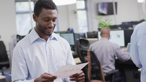 Portrait of happy african american businessman working with colleagues in office, slow motion