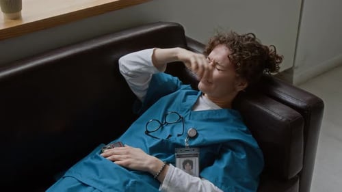 Healthcare Worker Resting on Couch in Hospital