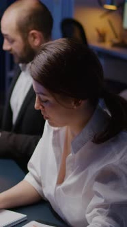 Vertical Video Portrait of Smiling Businesswoman Looking Into Camera Working Overtime in Business