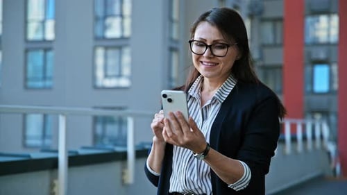 Middle Aged Woman Talking on Video Call Using Smartphone Urban Outdoor City