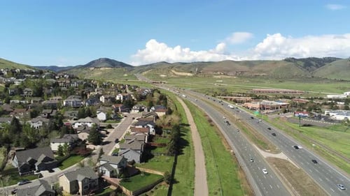 A reverse drone pan over I 70 with cars traveling towards Denver Colorado