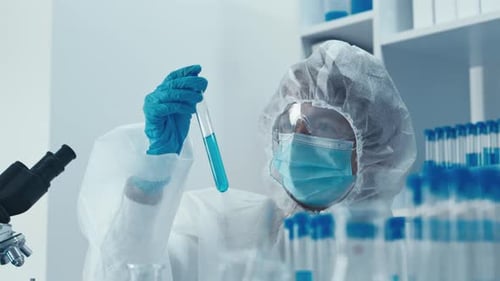 Scientist Examining Blue Liquid in Test Tube