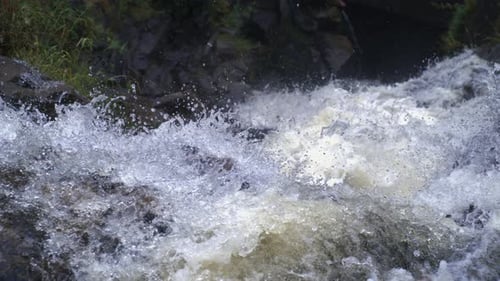 Water exploding upward from a rocky cascade in Ultra slow motion captured with a high-speed camera