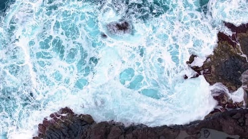 Waves crash on rocky shore at scenic coastal location