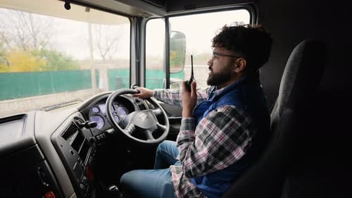 Truck Driver Communicating Using Cb Radio While Driving