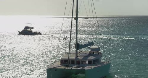 Palm Beach, Noord, Aruba - June 20 2016: Sailboat Along Coast In Ocean At Sunrise, Aerial Drone