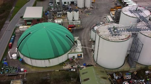 Industrial green domed food waste biodegradable recycling silo facility aerial rising view looking d