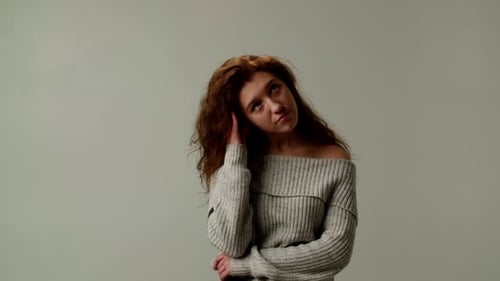 Woman Posing and Touching Face in Studio