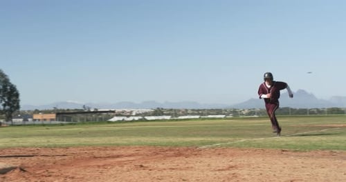 Playing baseball, athlete in uniform standing on base during game