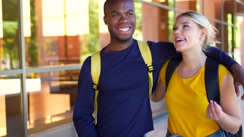 Multiethnic Friends Embracing From Shoulder Walking Along the University