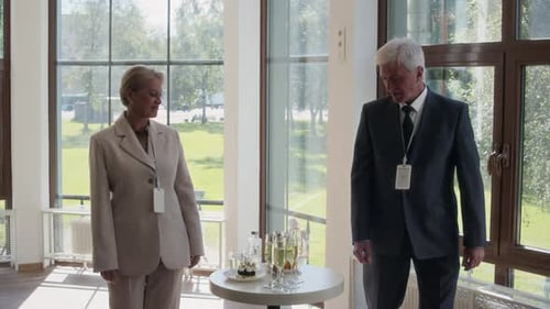 Senior Business People Taking Glasses of Champagne