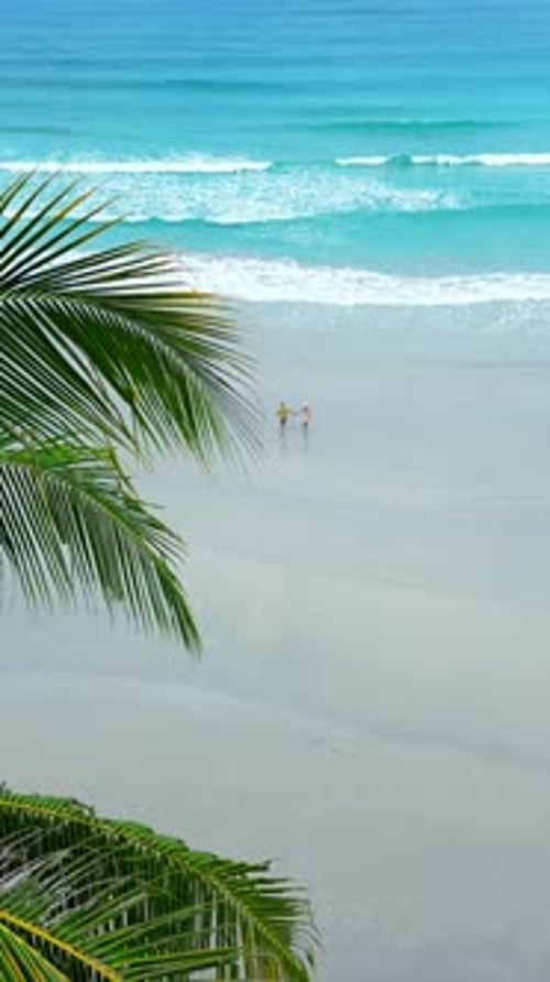 Happy Young Couple Enjoys Summer Vacation on an Empty Tropical Beach in Thailand