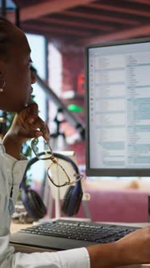 Professional Woman Coding at Computer in Modern Office