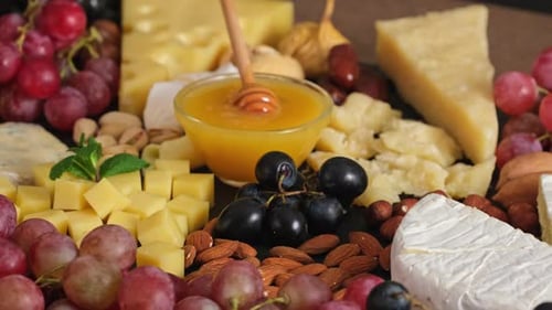 Gourmet Cheese Board with Grapes, Nuts, and Honey