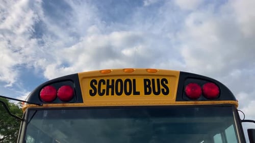 Nahaufnahme des Schulbusses auf der Rückseite, die die Vorderspiegel des an der Schule geparkten Busses zeigt; 4K