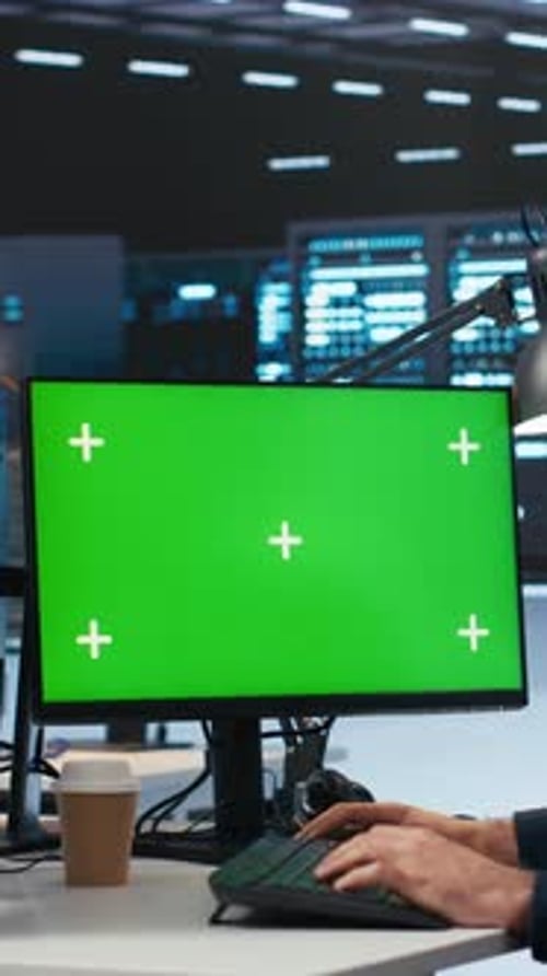Vertical Video Technician Overseeing Server Room Running Code on Green Screen Computer