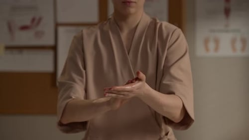 Thérapeute réchauffant l'huile de massage dans les mains avant la séance