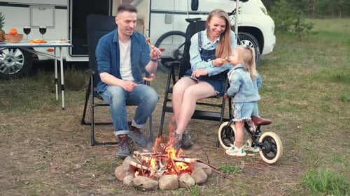 Family Camping Trip by Campfire with RV