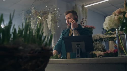 Male Florist Collects Bouquet Talks By Phone and Uses Tablet