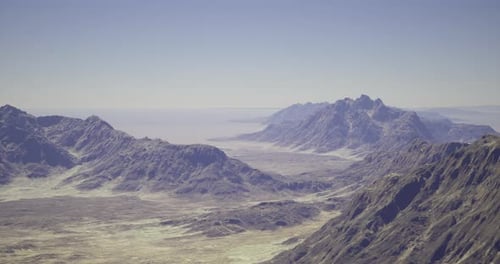 Stunning View of Rugged Mountain Landscape Under Clear Sky at Distant Horizon