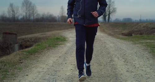 Active Senior Man Jogging on Country Road