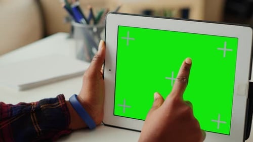 Tablet with Green Screen Being Tapped