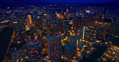 Flight over the stunning luminous panorama of the modern lively city at night.