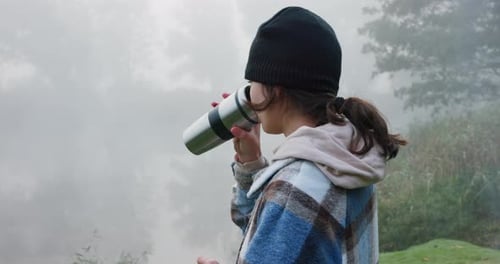 Young Adult Drinks By Foggy Lake