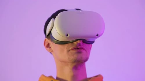 Young Adult Using VR Headset in Cool Lighting