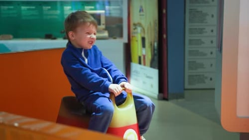 Childrens Entertainment Joyful Male Child Have Fun Riding Indoor Swing