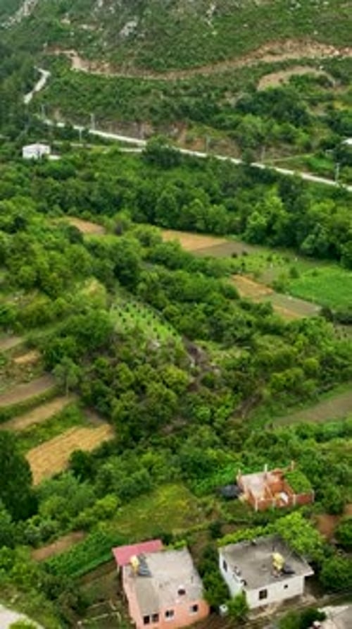 Vertical Video Village in the Rain Aerial Perspective of a Mountain Retreat