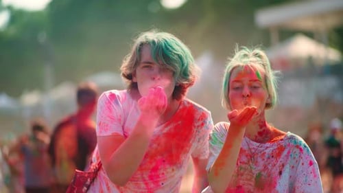 Friends Celebrate Holi Festival Blowing Colorful Powder