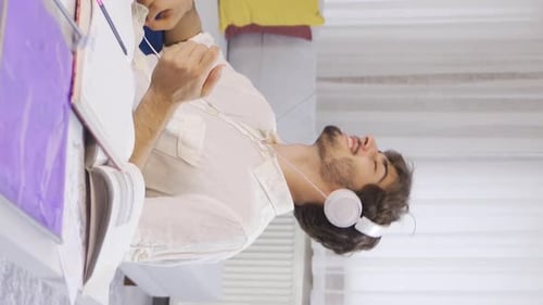 Young Man Listening and Singing to Music at Home