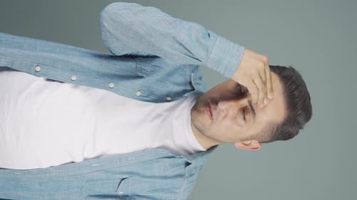 Man Rubs Temples Due to Headache Pain