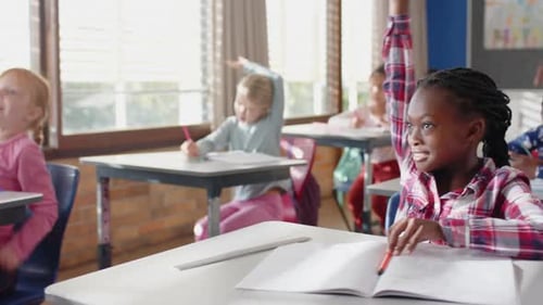 In school, students raising hands and participating actively in classroom activities