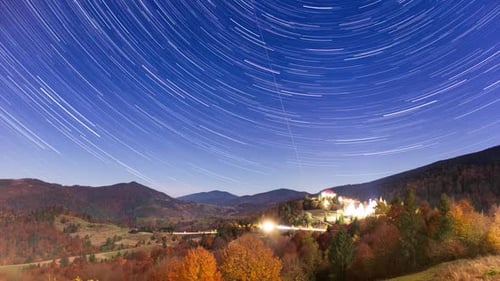 Star Trails Over Rural Mountain Autumn Landscape