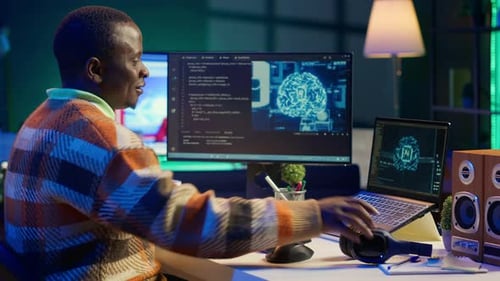 African American Worker at Desk Using Personal Computer for Programming