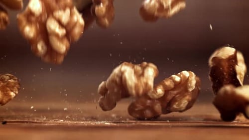 Walnuts Falling in Slow Motion onto Wood