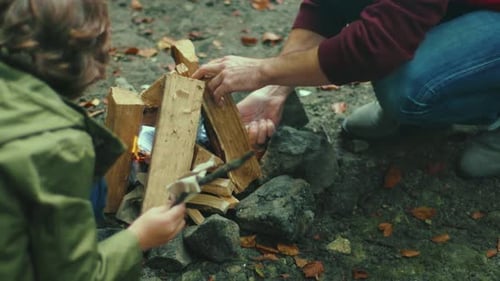 Hands Father and Daughter in the Woods Sets Up Campfire Sticks Talking Smiling Feel Happy Family