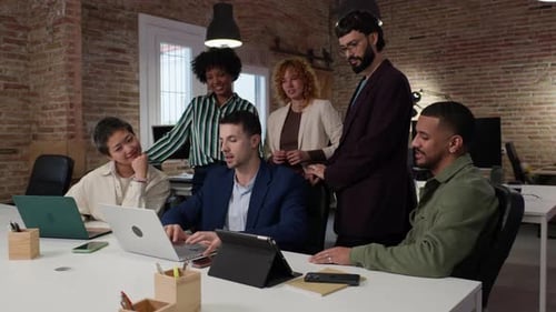 Coworkers Collaborating on Project in Modern Office in Slow Motion